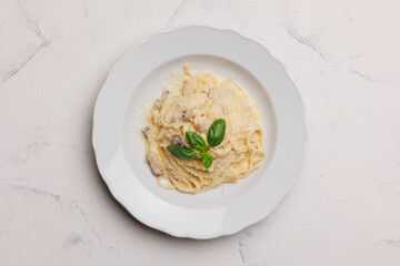 Italian pasta with meat and parmesan in a large white plate.