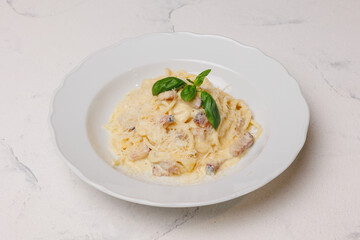Italian pasta with meat and parmesan in a large white plate.