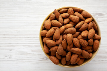 Roasted Organic Almonds in a Bowl, top view. Flat lay, overhead, from above. Copy space.