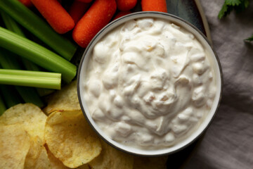 Homemade Carmelized Onion Dip with Baby Carrots, Chips and Celery, top view.