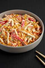Homemade Japanese Kani Salad with Crab Sticks and Vegetables on a Plate, side view.
