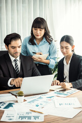 Diverse group of business analyst team analyzing financial data report paper on office table. Chart...