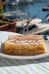 French mille-feuille cake, vanilla or custard slice, Napoleon puff pastry layered with pastry cream served outdoor in Port Grimaud, France