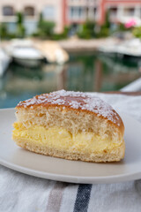 Cake of French Riviera, Tarte Tropezienne cake in yacht harbour of Port Grimaud, summer vacation in Provence, France