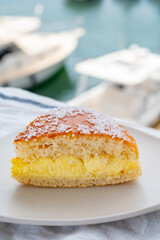 Cake of French Riviera, Tarte Tropezienne cake in yacht harbour of Port Grimaud, summer vacation in Provence, France
