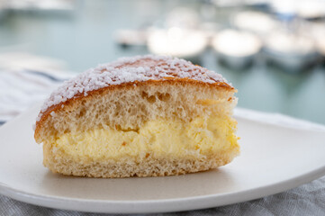 Cake of French Riviera, Tarte Tropezienne cake in yacht harbour of Port Grimaud, summer vacation in Provence, France