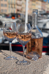Glasses of cold rose Cote de Provence wine in old fisherman boats and yacht harbour in Saint-Tropez, summer vacation on French Riviera in Provence, France