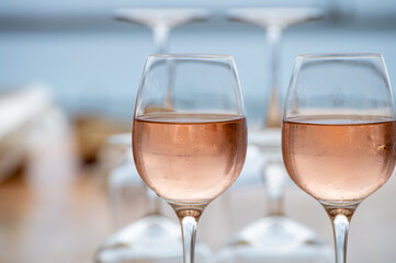 Summer time in Provence, two glasses of cold rose wine with blue sea view on background, French Riviera near Menton, south of France