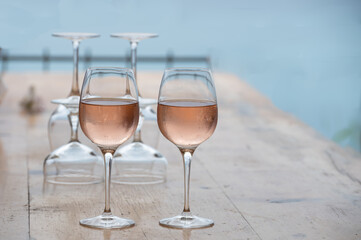 Summer time in Provence, two glasses of cold rose wine with blue sea view on background, French Riviera near Menton, south of France