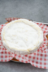 french soft Camembert cheese, original Camembert de Normandie, close up with white mold