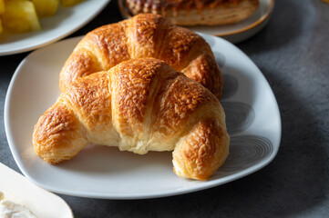 Fresh baked two buttered croissants served in restaurant for continental or French breakfast close up
