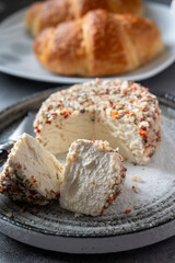 French cheese collection, fresh white soft goat cheese with aromatic herbs, garlic, parsley and red peppers close up