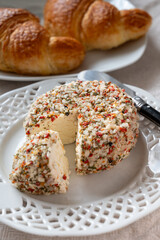 French cheese collection, fresh white soft goat cheese with aromatic herbs, garlic, parsley and red peppers close up