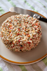 French cheese collection, fresh white soft goat cheese with aromatic herbs, garlic, parsley and red peppers close up