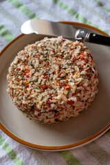 French cheese collection, fresh white soft goat cheese with aromatic herbs, garlic, parsley and red peppers close up