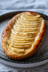 French fresh baked sweet puff pastry with fresh apple fruits in sirup in confectionery shop
