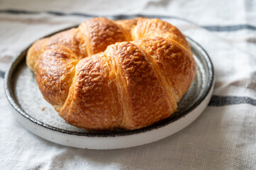 Fresh baked two buttered croissants served in restaurant for continental or French breakfast close up