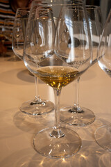 Tasting of sweet Bordeaux white wine in Sauternes, left bank of Gironde Estuary, France. Glasses of white sweet French wine served in restaurant