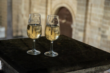 Sherry wine glasses with fino and old church on background at night in Jerez de la Frontera, wine...