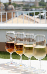 Sherry wine tasting on roof of old Triana district in Sevilla with view on Sevilla houses and churches, wine glasses