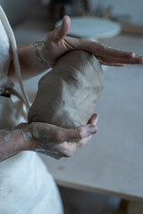 Making of mud pot on potters wheel during workshop in art ceramic atelier in Poland