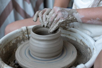 Making of mud pot on potters wheel during workshop in art ceramic atelier in Poland