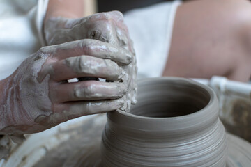 Making of mud pot on potters wheel during workshop in art ceramic atelier in Poland