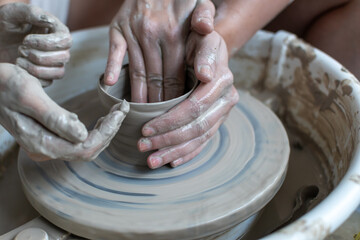 Making of mud pot on potters wheel during workshop in art ceramic atelier in Poland
