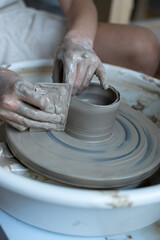 Making of mud pot on potters wheel during workshop in art ceramic atelier in Poland