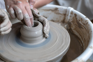 Making of mud pot on potters wheel during workshop in art ceramic atelier in Poland