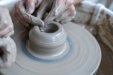 Making of mud pot on potters wheel during workshop in art ceramic atelier in Poland
