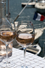 Glasses of cold rose gris Cote de Provence wine in yacht harbour of Port Grimaud, summer vacation on French Riviera in Provence, France
