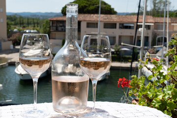 Glasses of cold rose gris Cote de Provence wine in yacht harbour of Port Grimaud, summer vacation on French Riviera in Provence, France