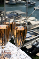 Summer party, French brut rose champagne sparkling wine in flute glasses in yacht harbour of Port Grimaud near Saint-Tropez, French Riviera vacation, Var, France