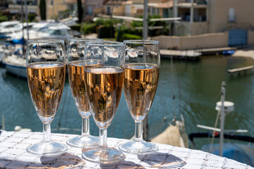 Summer party, French brut rose champagne sparkling wine in flute glasses in yacht harbour of Port Grimaud near Saint-Tropez, French Riviera vacation, Var, France