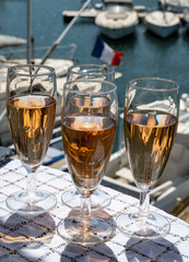 Summer party, French brut rose champagne sparkling wine in flute glasses in yacht harbour of Port Grimaud near Saint-Tropez, French Riviera vacation, Var, France