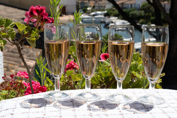 Summer party, French brut rose champagne sparkling wine in flute glasses in yacht harbour of Port Grimaud near Saint-Tropez, French Riviera vacation, Var, France