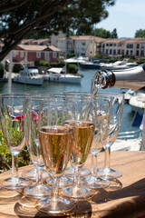 Summer party, French brut rose champagne sparkling wine in flute glasses in yacht harbour of Port Grimaud near Saint-Tropez, French Riviera vacation, Var, France