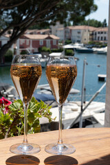 Summer party, French brut rose champagne sparkling wine in flute glasses in yacht harbour of Port Grimaud near Saint-Tropez, French Riviera vacation, Var, France