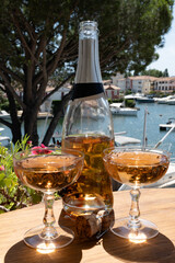 Summer party, French brut rose champagne sparkling wine in coupe glasses in yacht harbour of Port Grimaud near Saint-Tropez, French Riviera vacation, Var, France