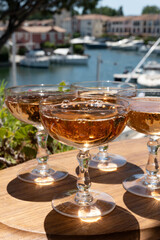 Summer party, French brut rose champagne sparkling wine in coupe glasses in yacht harbour of Port Grimaud near Saint-Tropez, French Riviera vacation, Var, France