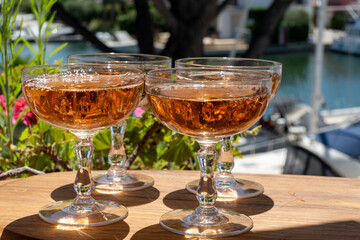 Summer party, French brut rose champagne sparkling wine in coupe glasses in yacht harbour of Port Grimaud near Saint-Tropez, French Riviera vacation, Var, France