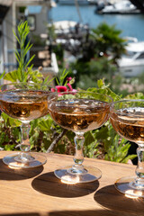 Summer party, French brut rose champagne sparkling wine in coupe glasses in yacht harbour of Port Grimaud near Saint-Tropez, French Riviera vacation, Var, France
