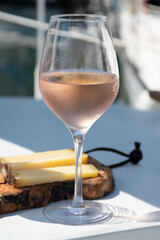 Party with rose wine on yacht boat anchored in port la Rague, Gulf of La Napoule, in Provence, two glasses of cold rose wine, French Riviera near Cannes, south of France