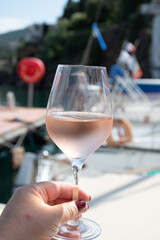 Party with rose wine on yacht boat anchored in port la Rague, Gulf of La Napoule, in Provence, two glasses of cold rose wine, French Riviera near Cannes, south of France