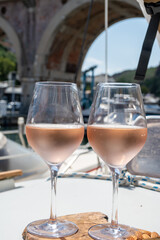 Party with rose wine on yacht boat anchored in port la Rague, Gulf of La Napoule, in Provence, two glasses of cold rose wine, French Riviera near Cannes, south of France