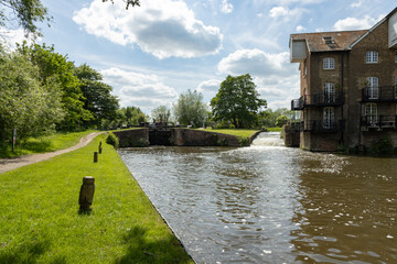 Coxes Lock and historic flour mill, now converted to apartments, on the River Wey Navigations in...