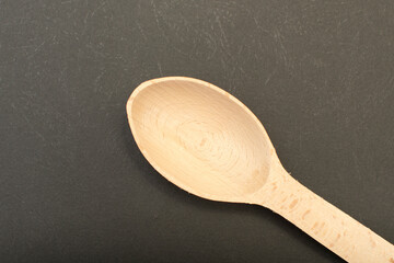 Wooden spoon on black background