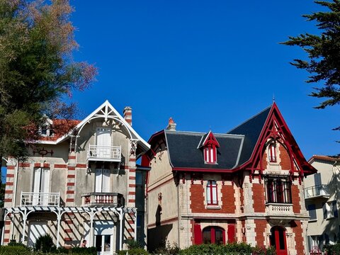 view of two typical houses of the Atlantic coast, one red and the other white on a sunny summer day
