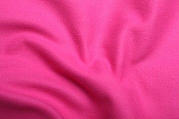 Fototapeta premium Crumpled pink microfiber cloth as background, closeup